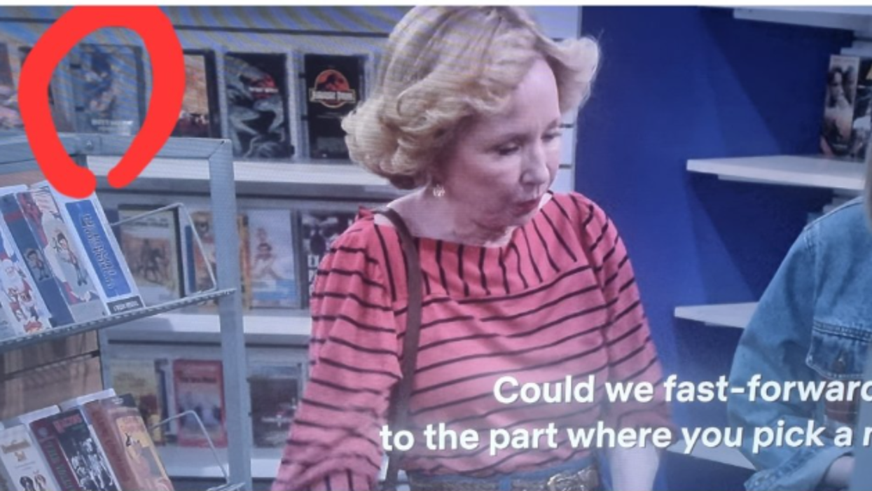 Kitty Foreman in a video store with Batman Forever visible in the background