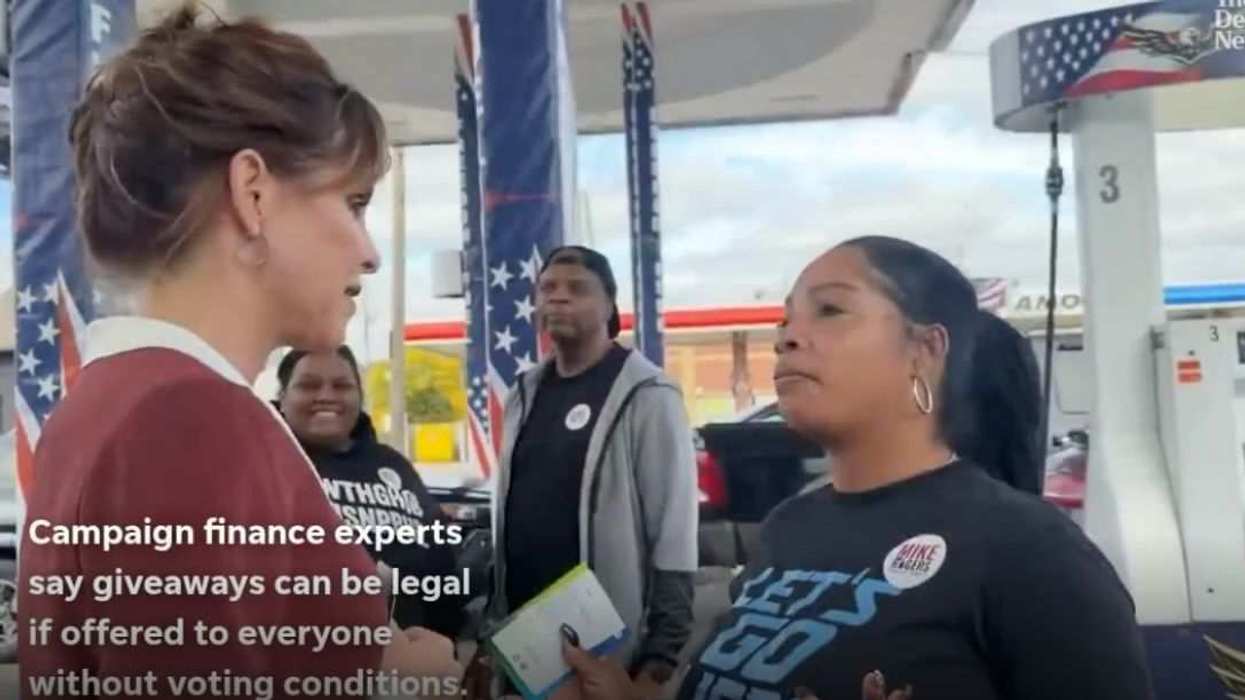 Kristi Rogers (left) at a Detroit gas station during her $10 gas card giveaway.