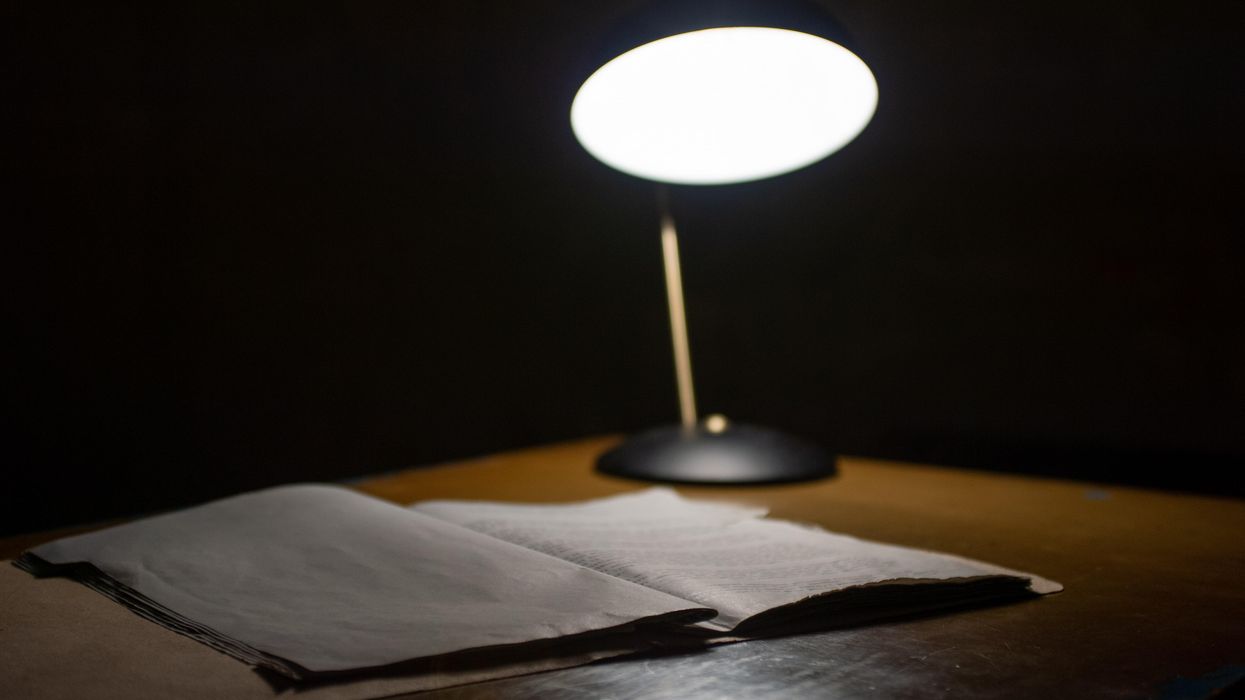 lamp and notebook on desk