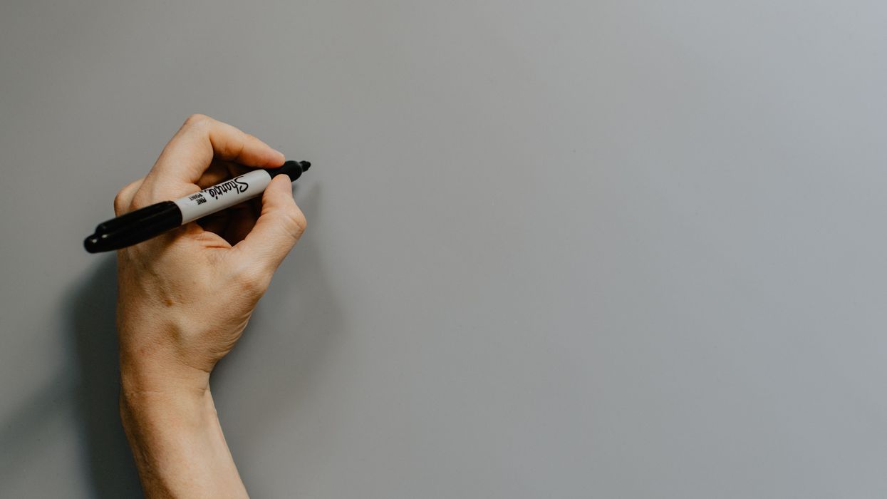 Left-handed person holding a Sharpie