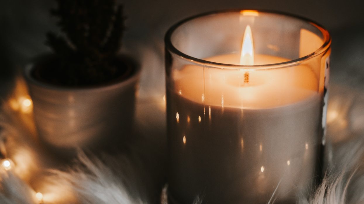 Lit candle in the dark