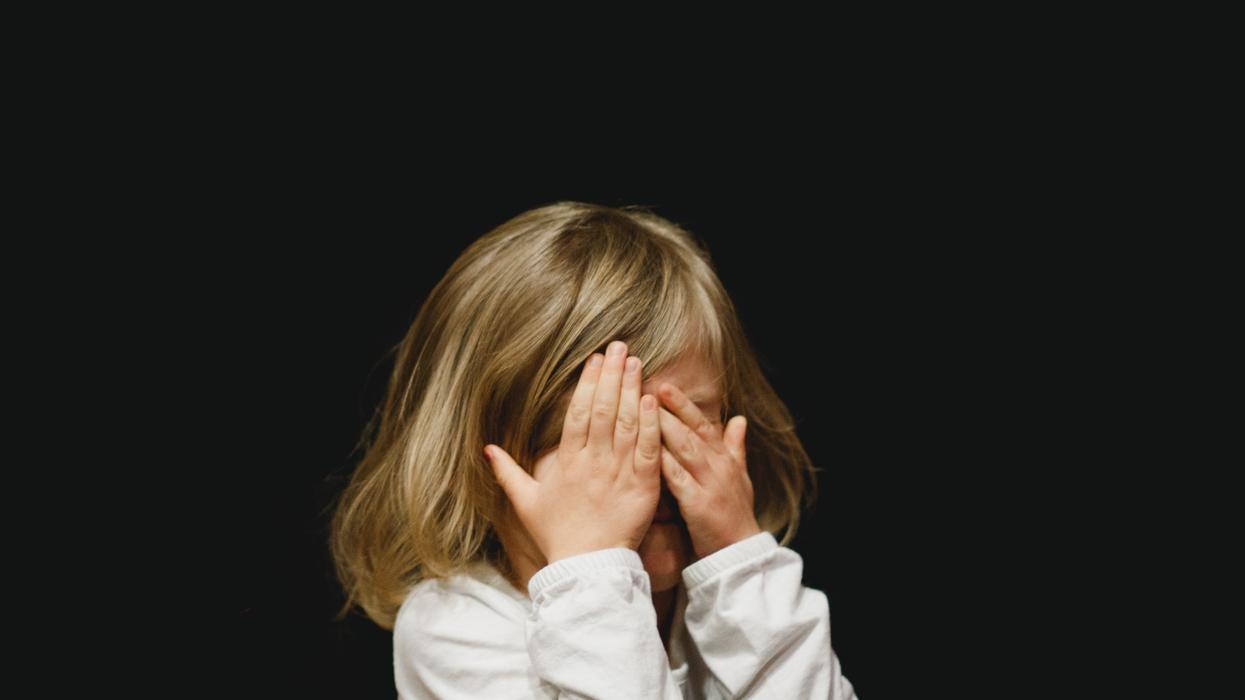 Little girl covering her eyes