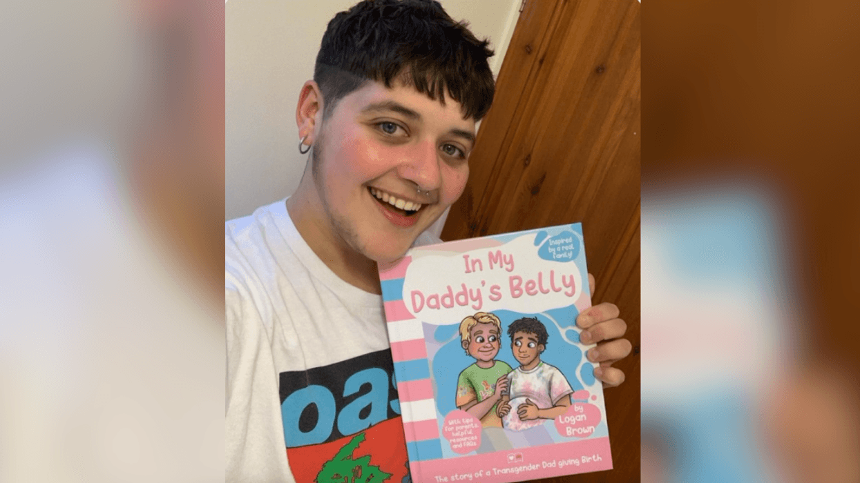 Logan Brown holding copy of "In My Daddy's Belly"