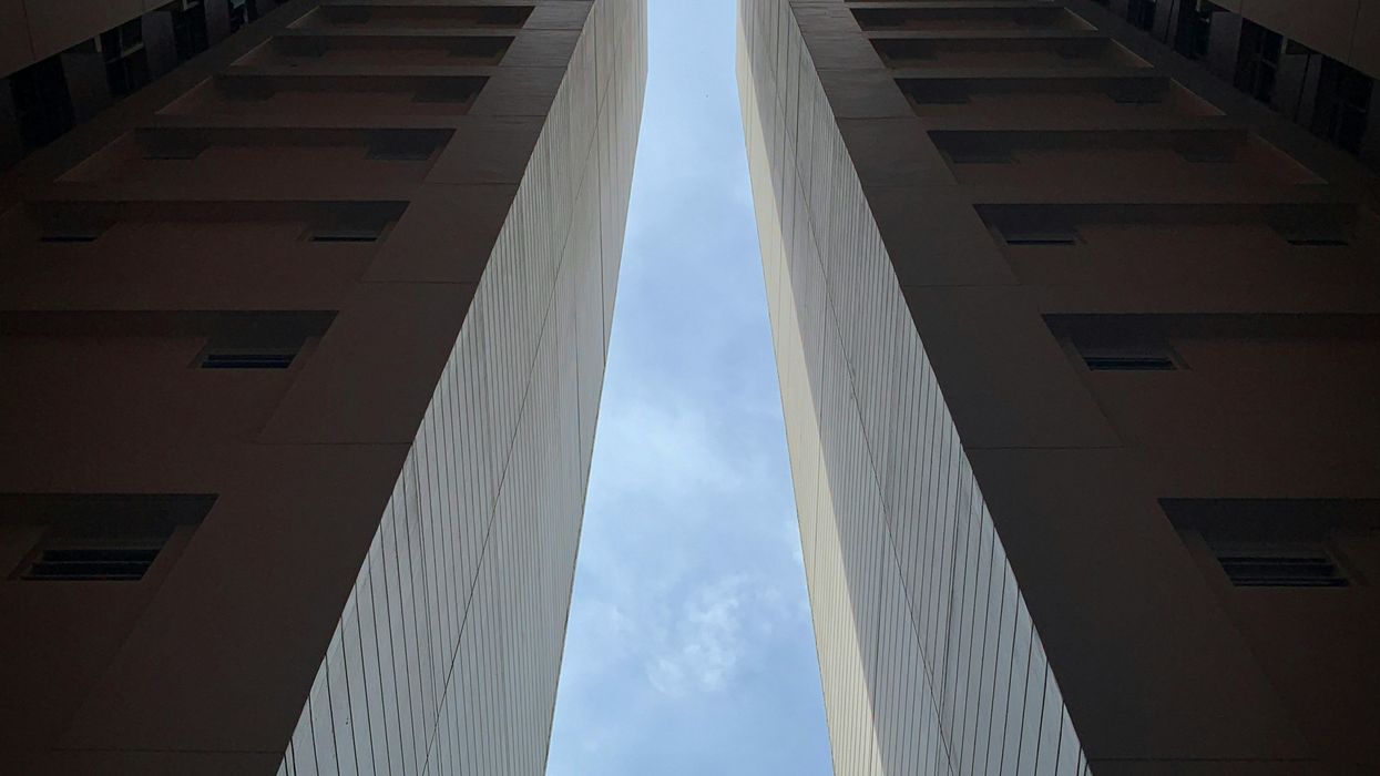 low-angle photo of high-rise buildings under blue sky