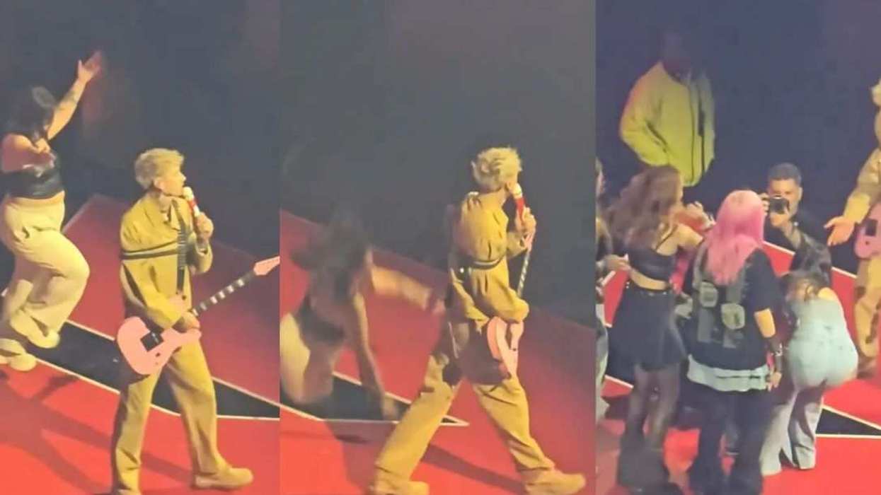 Machine Gun Kelly reacts after a fan accidentally falls through a gap in the stage during his Lost Americana tour stop.