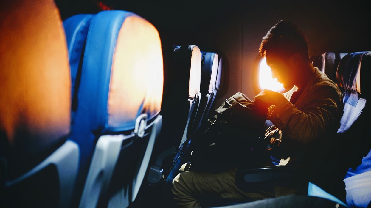 Male flight passenger looking through his bag