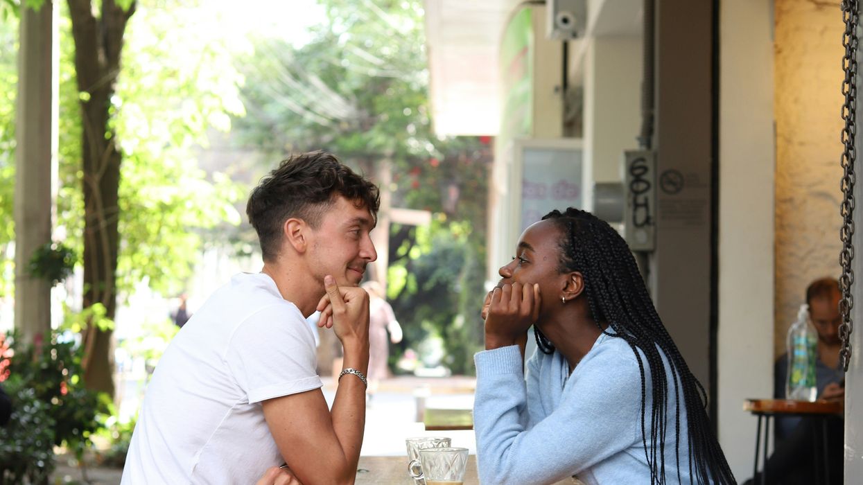 Man and woman playing footsie under table