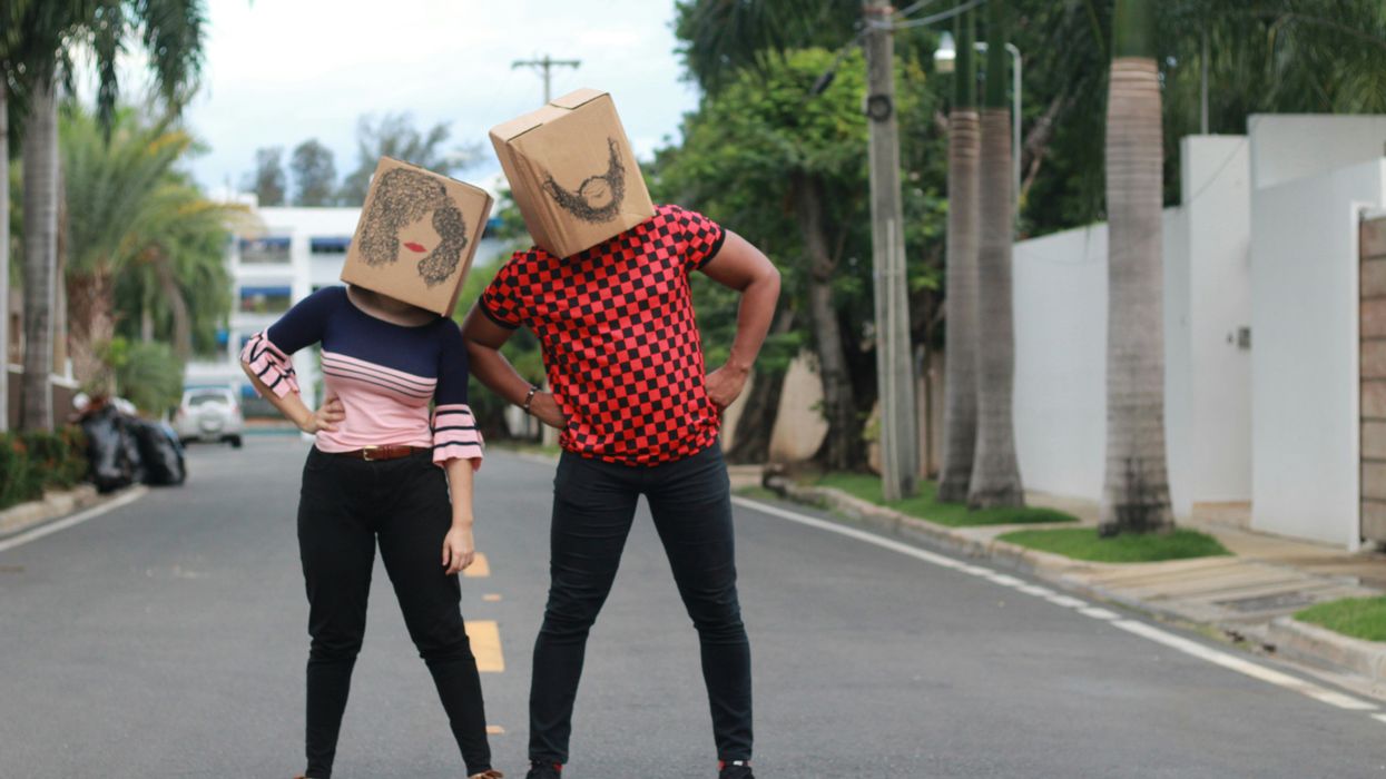 man and woman with cardboard boxes on their heads with faces drawn on them