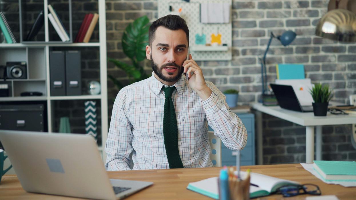 Man appearing shocked and regretful while on the phone