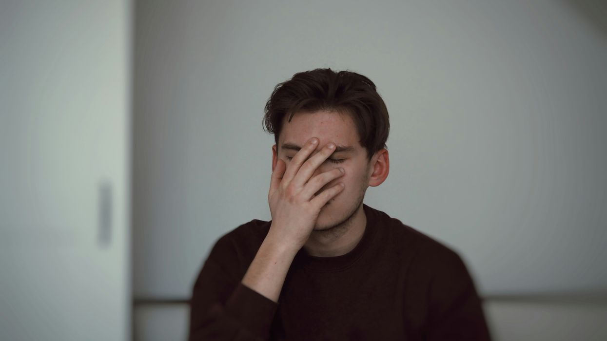 man covering his face