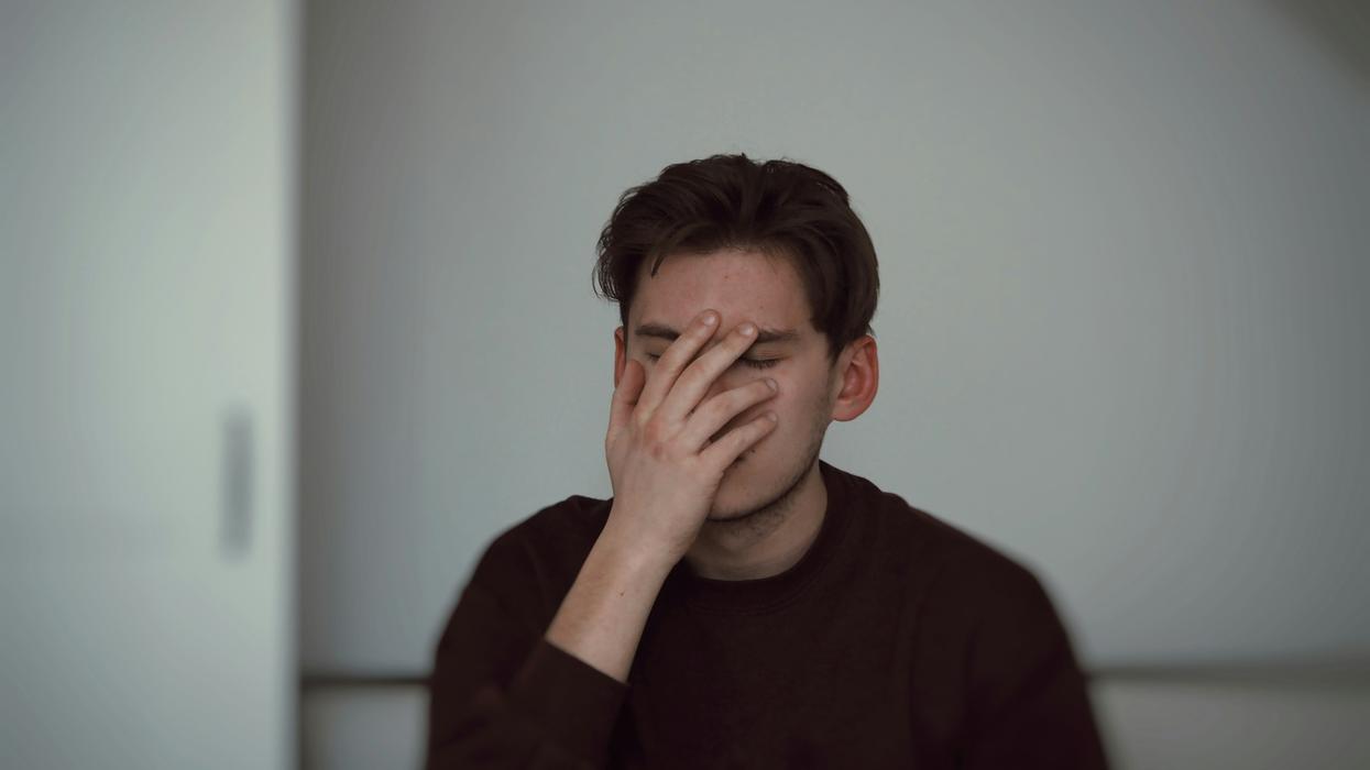 man covering his face