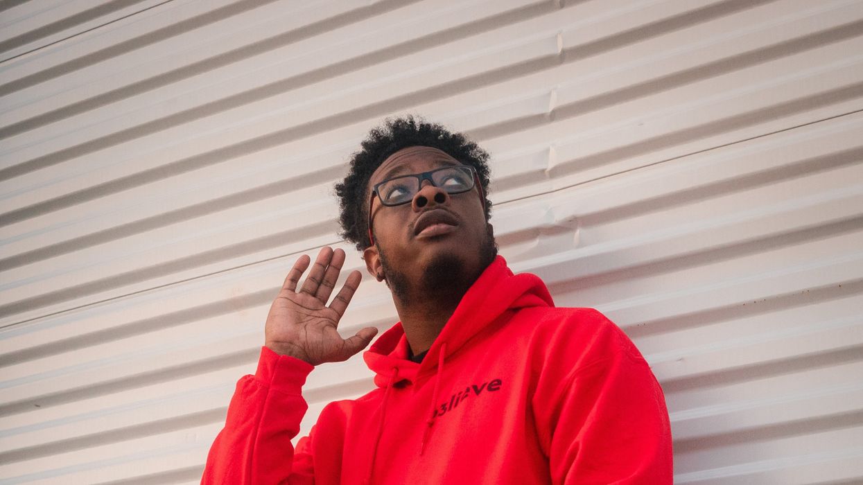 Man cupping his ear listening to something