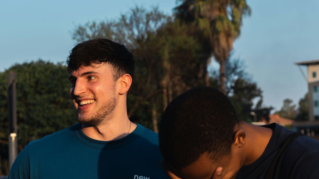 Man face palming next to a laughing friend