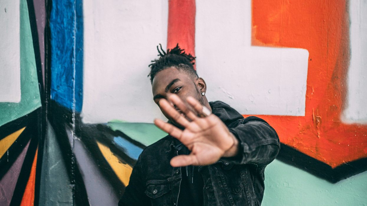 Man holding up his hand in a 'high five' gesture