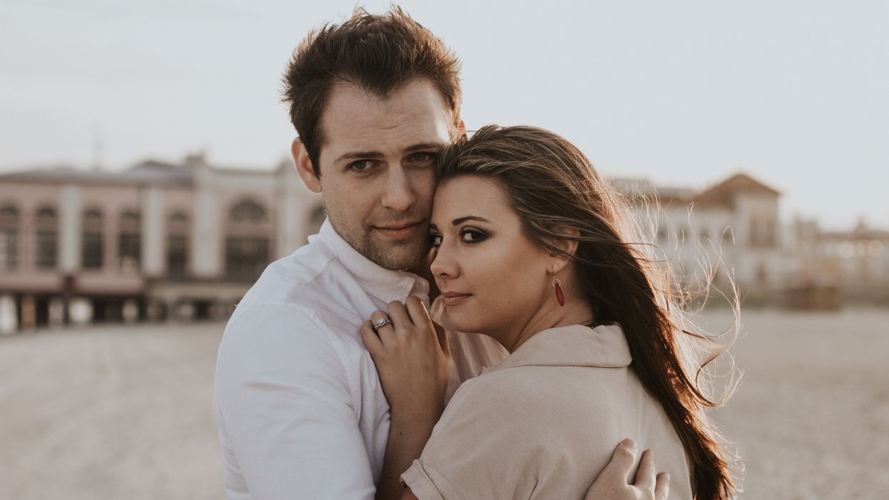 man hugging woman during daytime