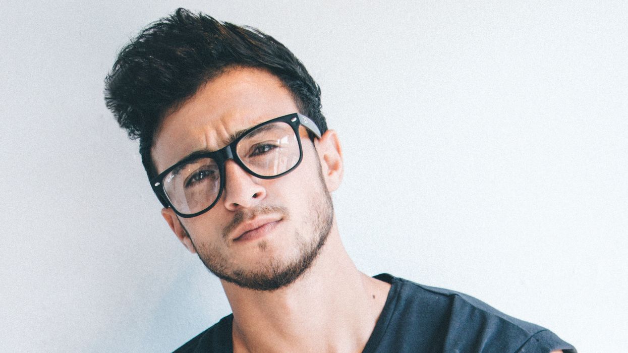 Man in a sleeveless shirt with his arms crossed.