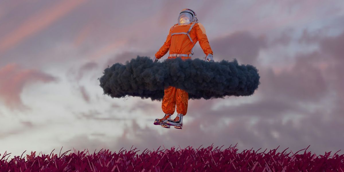 man in an orange spacesuit floating in the air