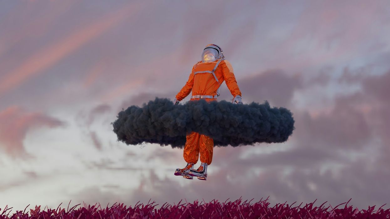 man in an orange spacesuit floating in the air
