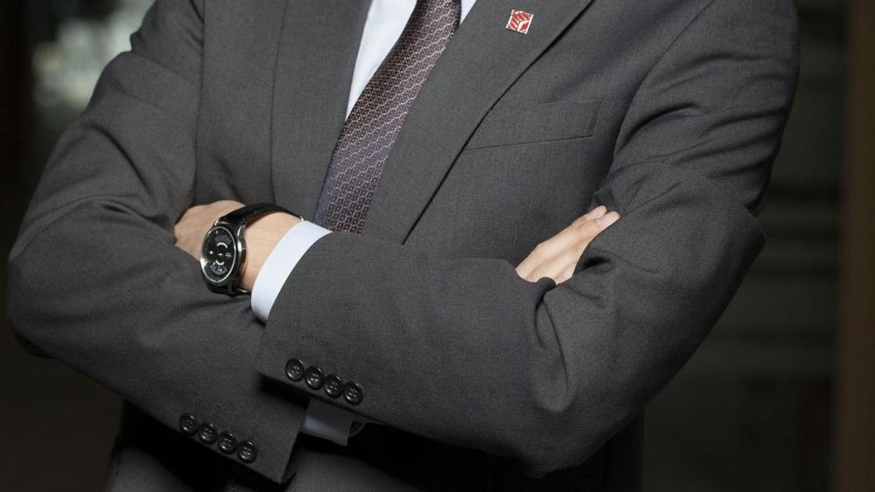 Man in business suit with arms crossed
