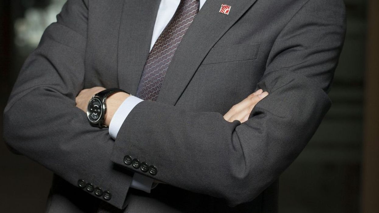 Man in business suit with arms crossed