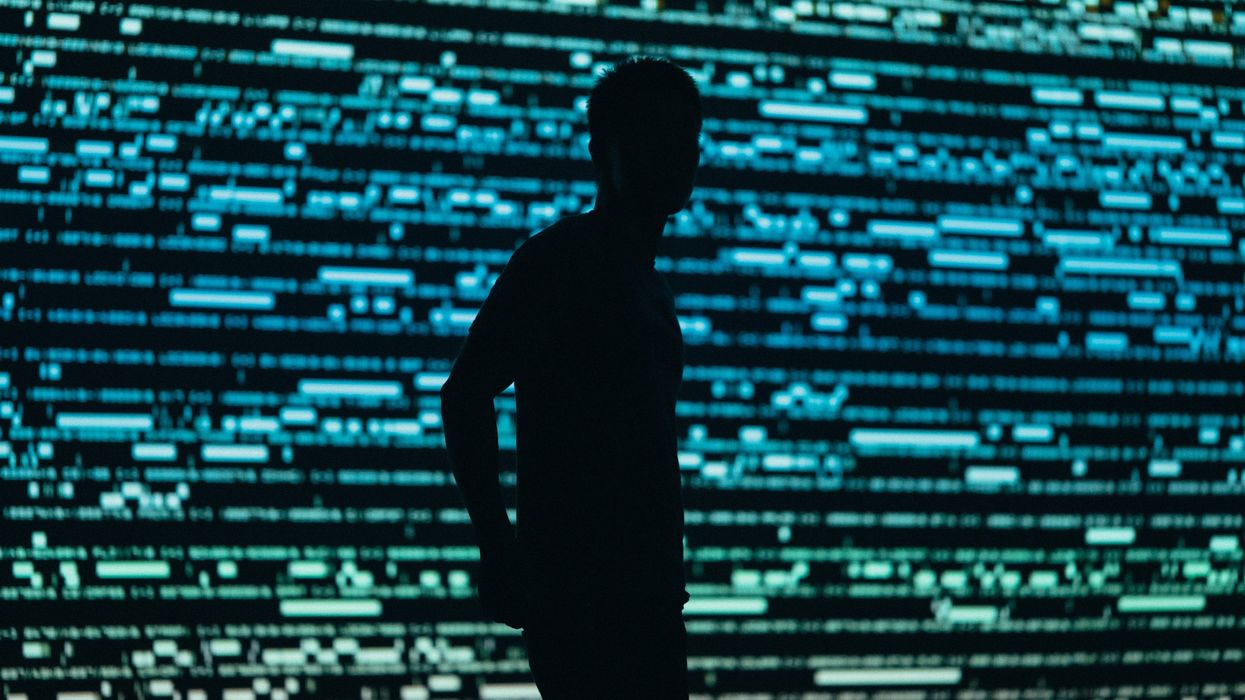 man in front of computer code