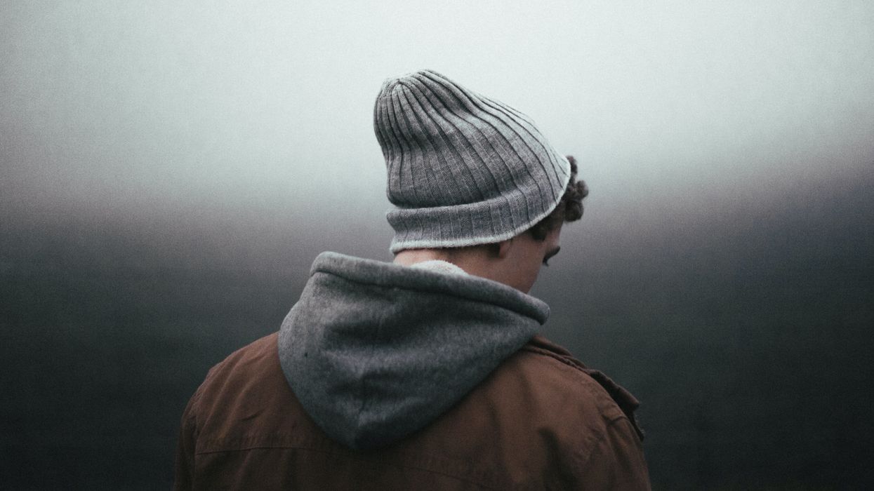 Man in knit cap looking sad