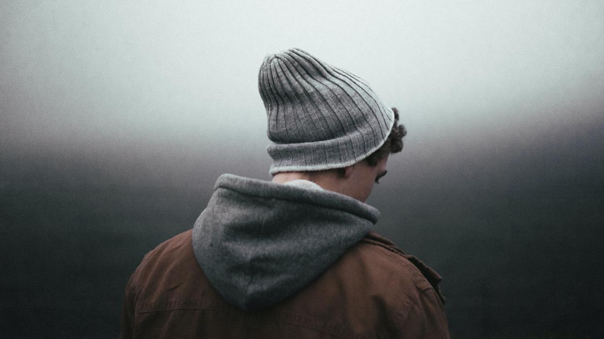 Man in knit cap looking sad