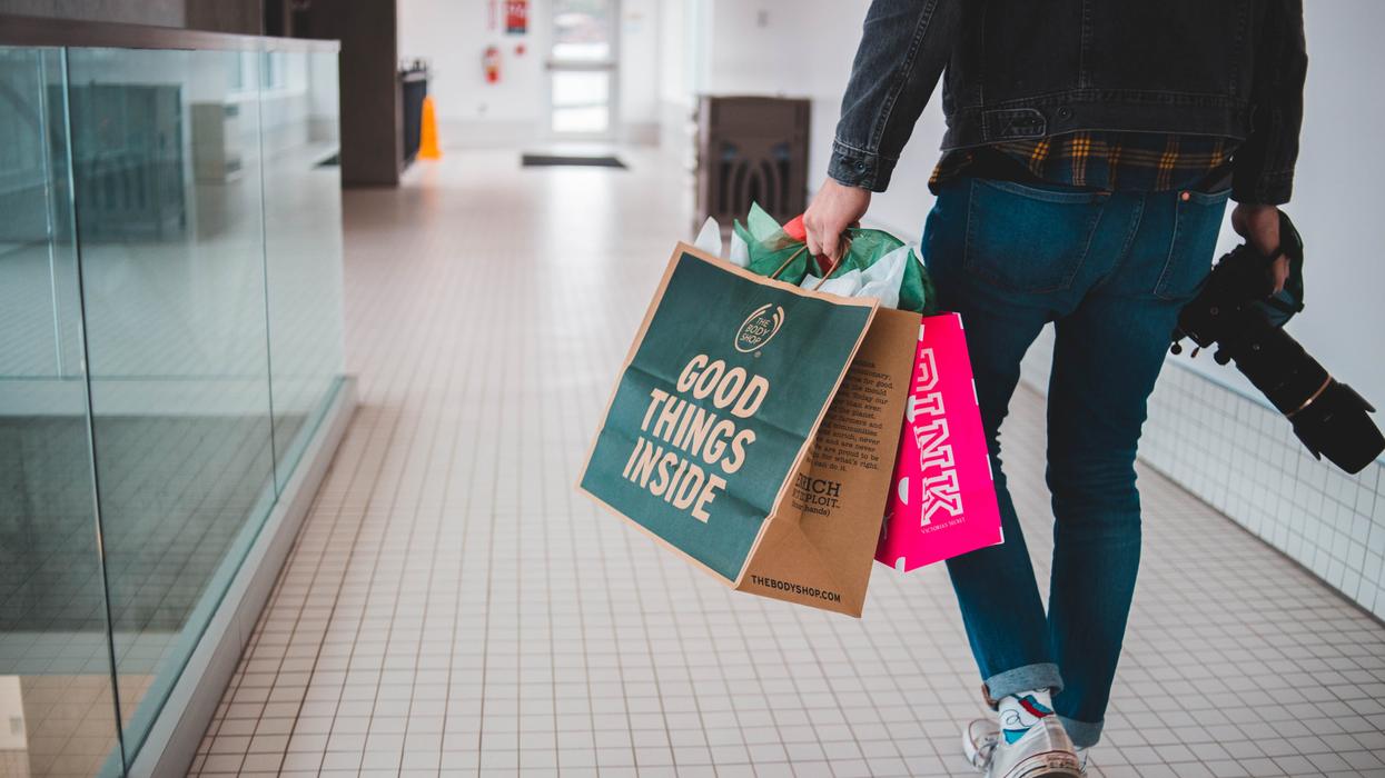 Man in mall with shopping bags