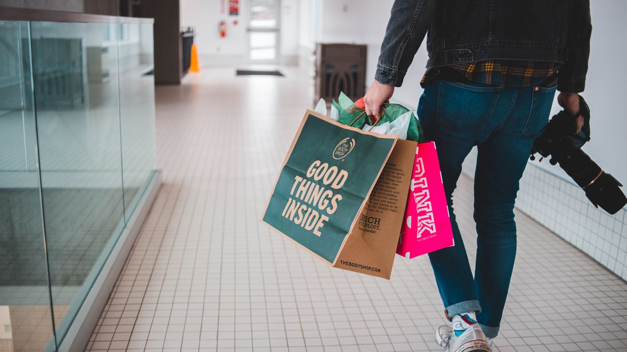 Man in mall with shopping bags