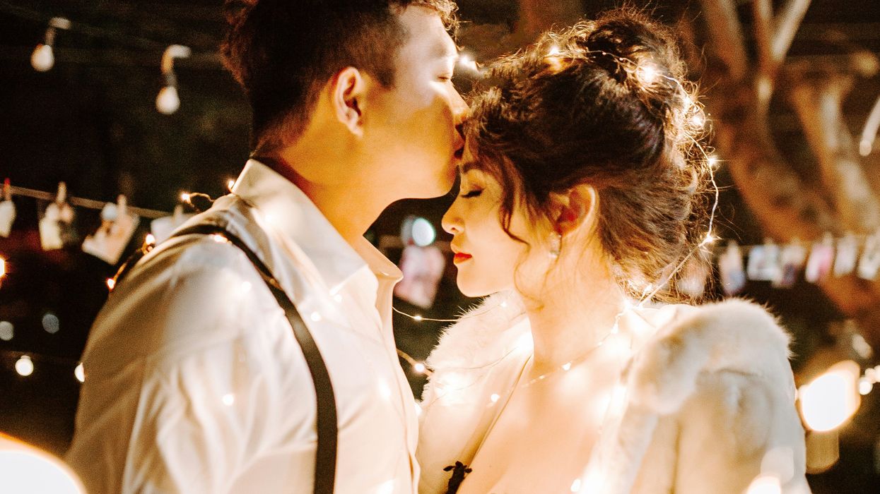 Man kissing woman's forehead