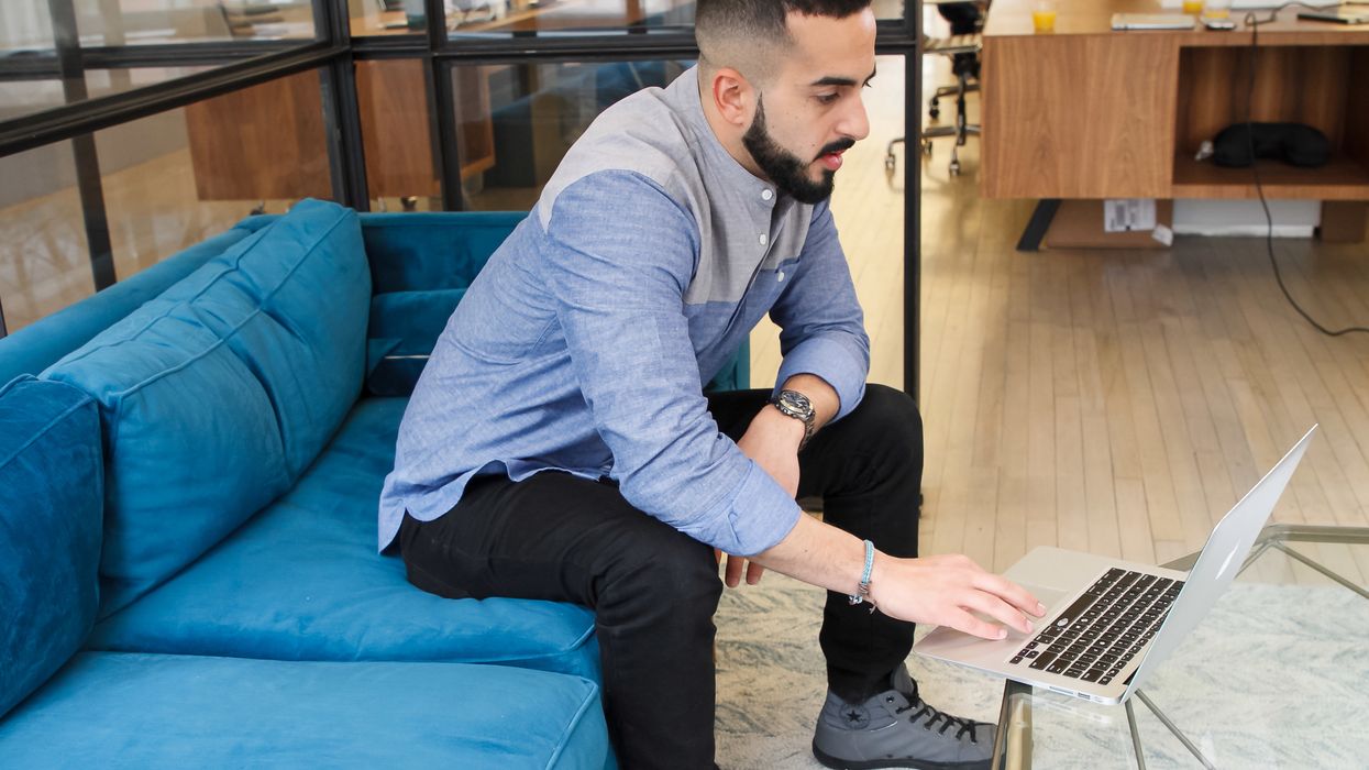 Man looking dejectedly at his laptop
