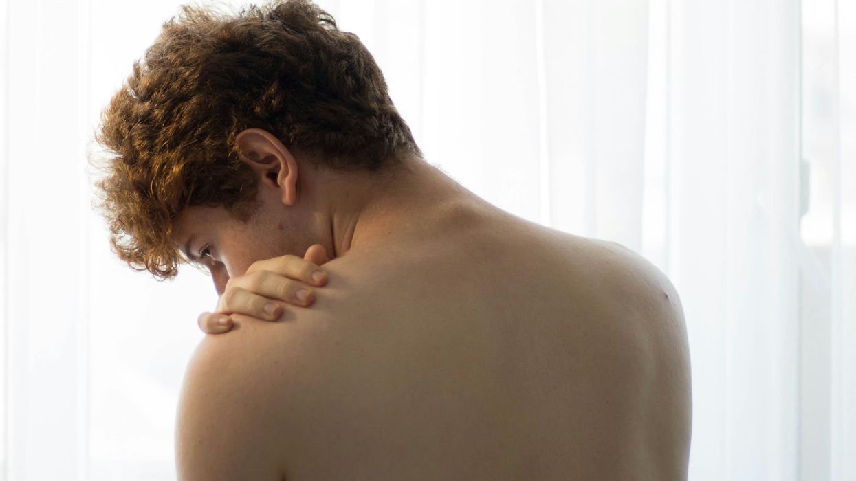 Man placing his hand on his shoulder