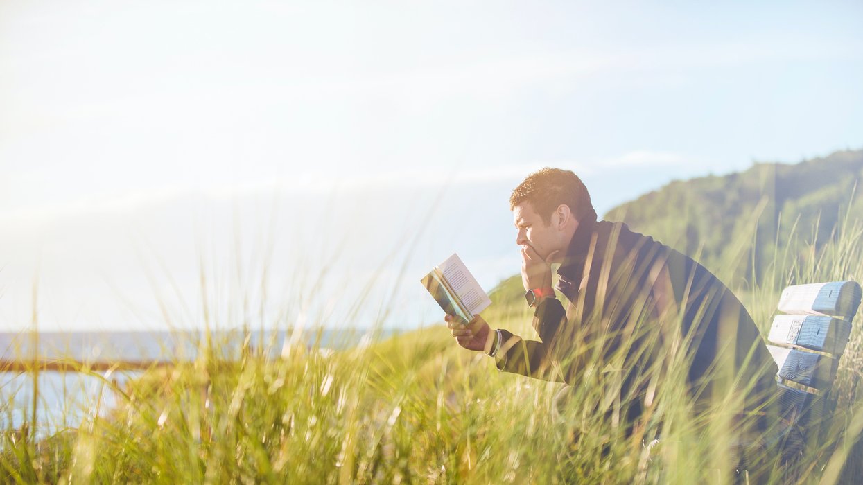 Man reading book in nature