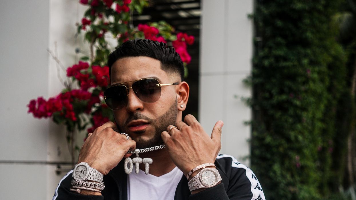 Man showing off expensive, chunky jewelry