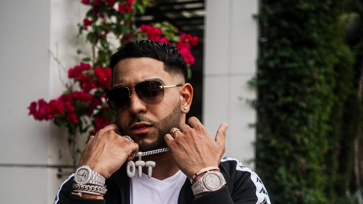 Man showing off expensive, chunky jewelry