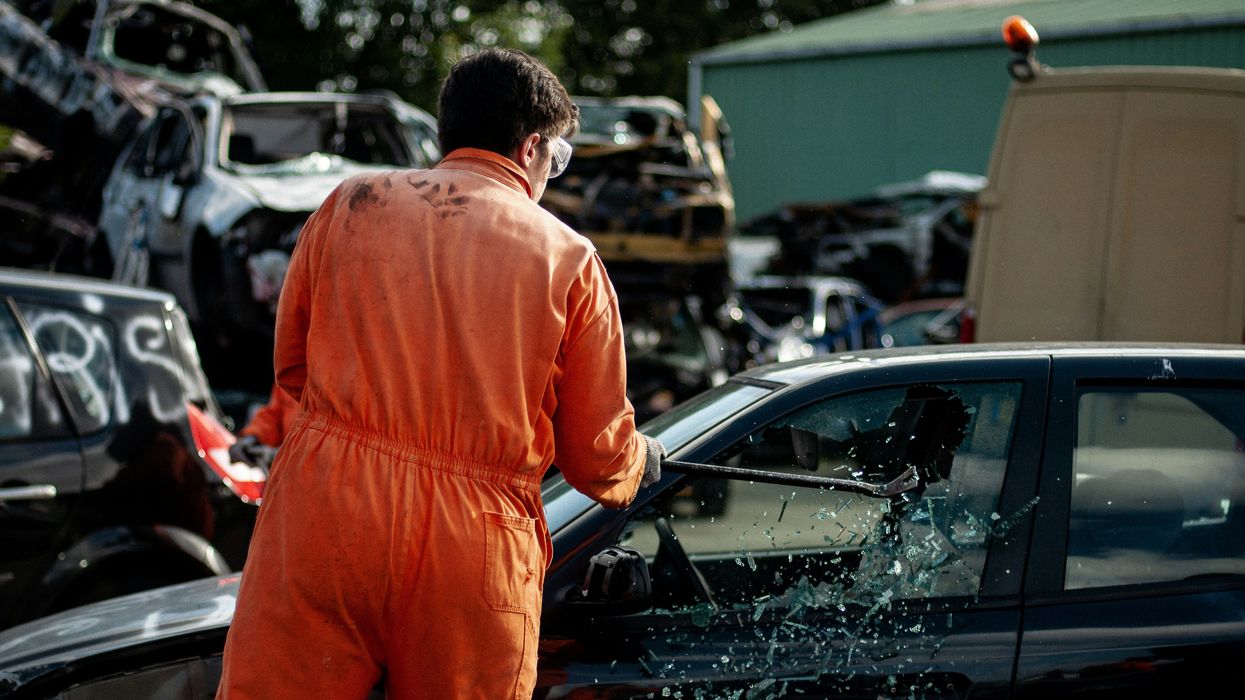 Man smashing car window with golf club