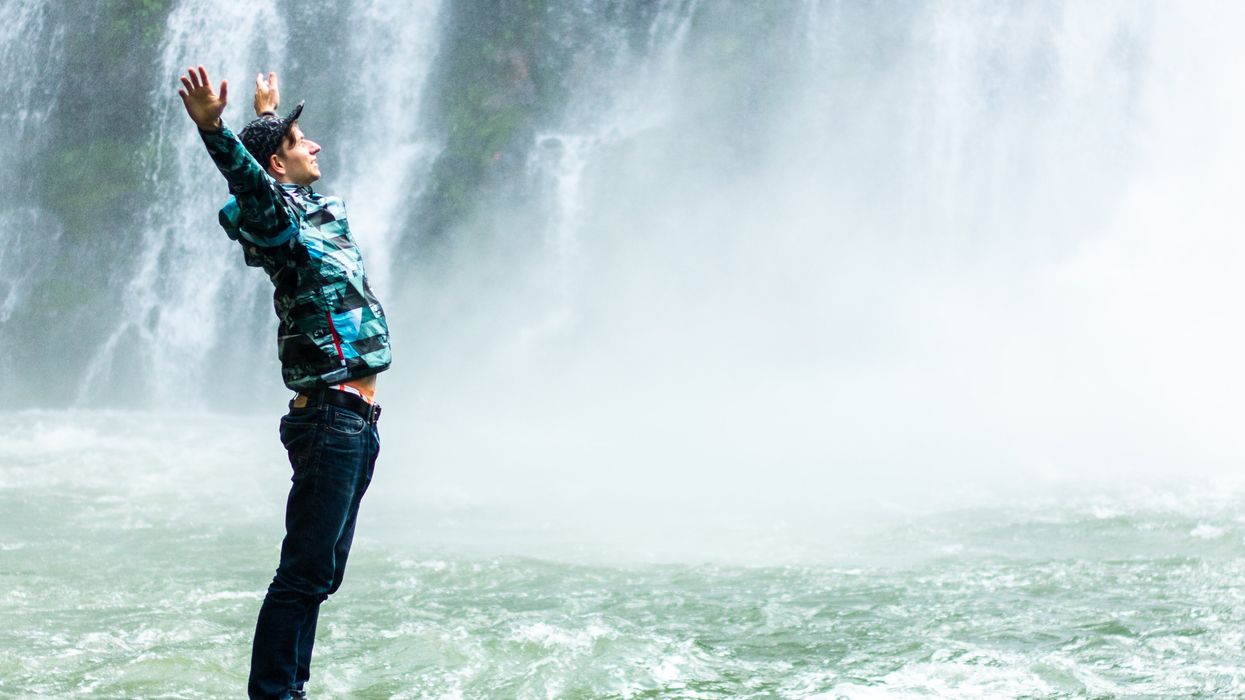 Man standing in front of waterfalls