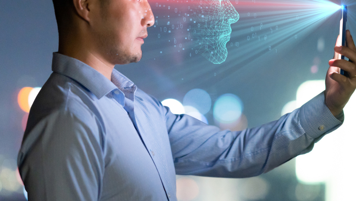 Man using face recognition technology on his cell phone