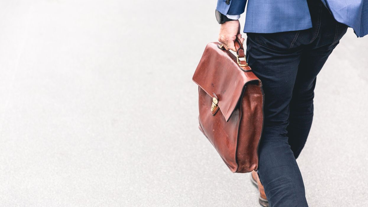 Man walking away with a briefcase