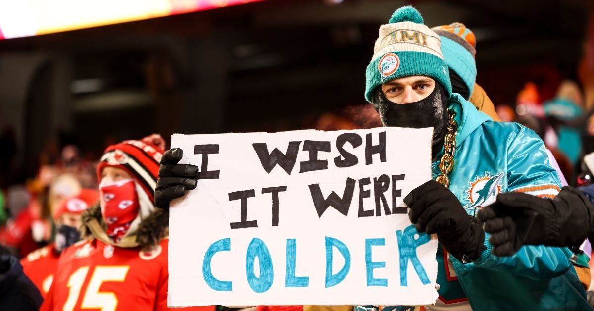 Miami fan holding a sign that reads, "I wish it were colder" 