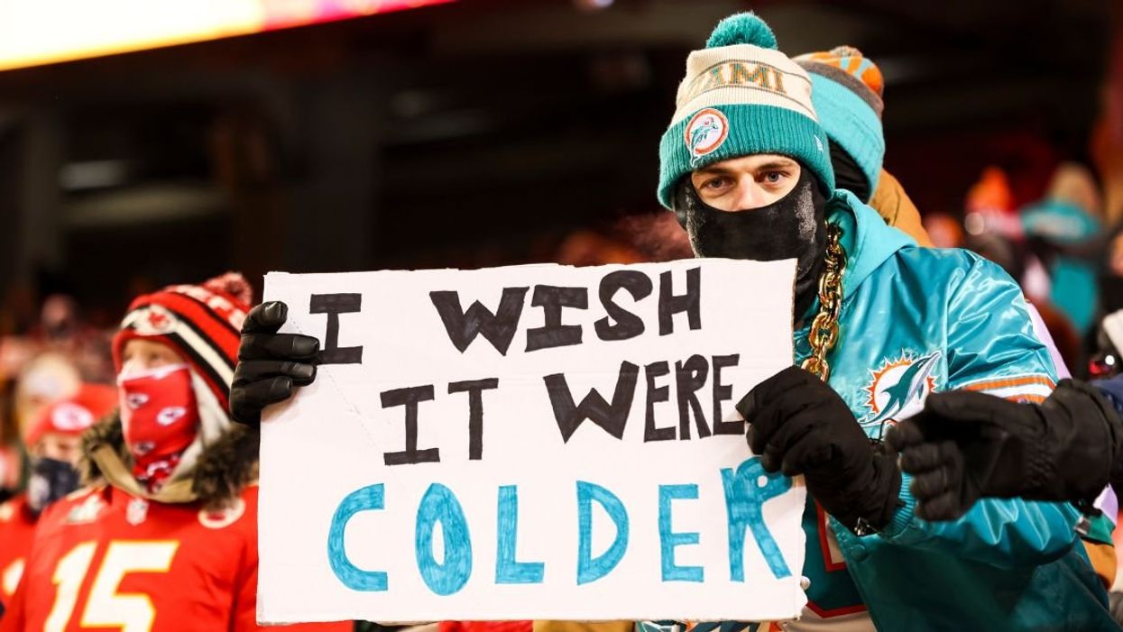 Miami fan holding a sign that reads, "I wish it were colder"