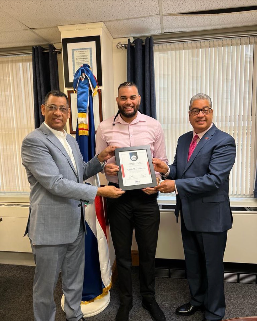 Molina receiving framed certificate by the Dominican consulate in Boston
