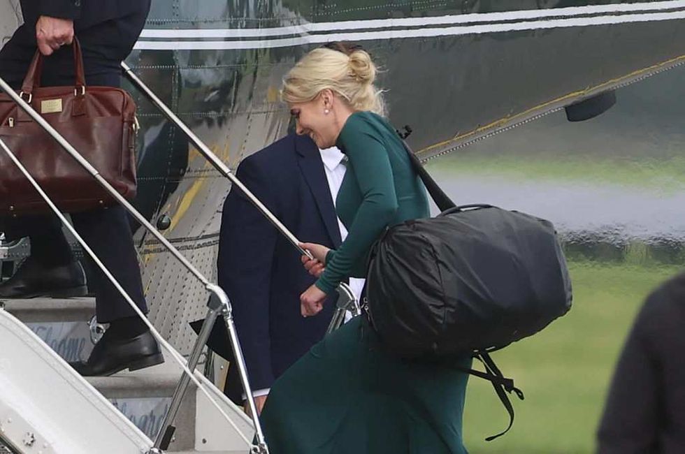Natalie Harp boarding Air Force One with duffel bag