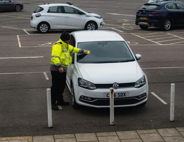 Officer issuing parking ticket