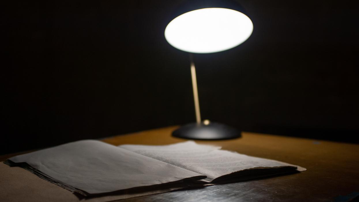 Open book and lamp on a desk