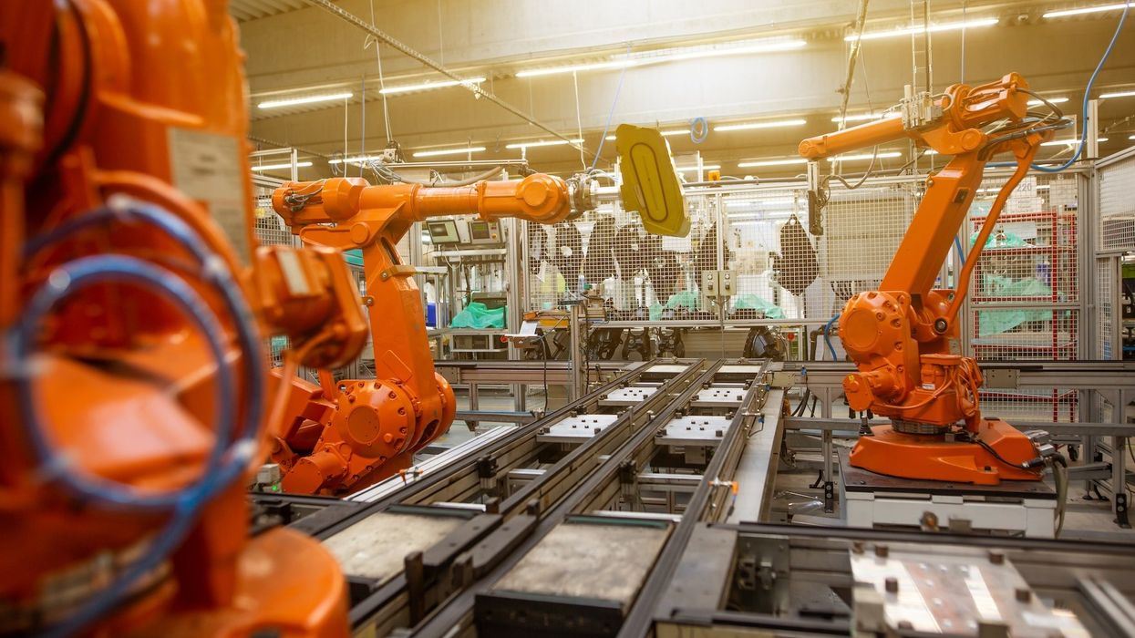 Orange machines work the assembly line