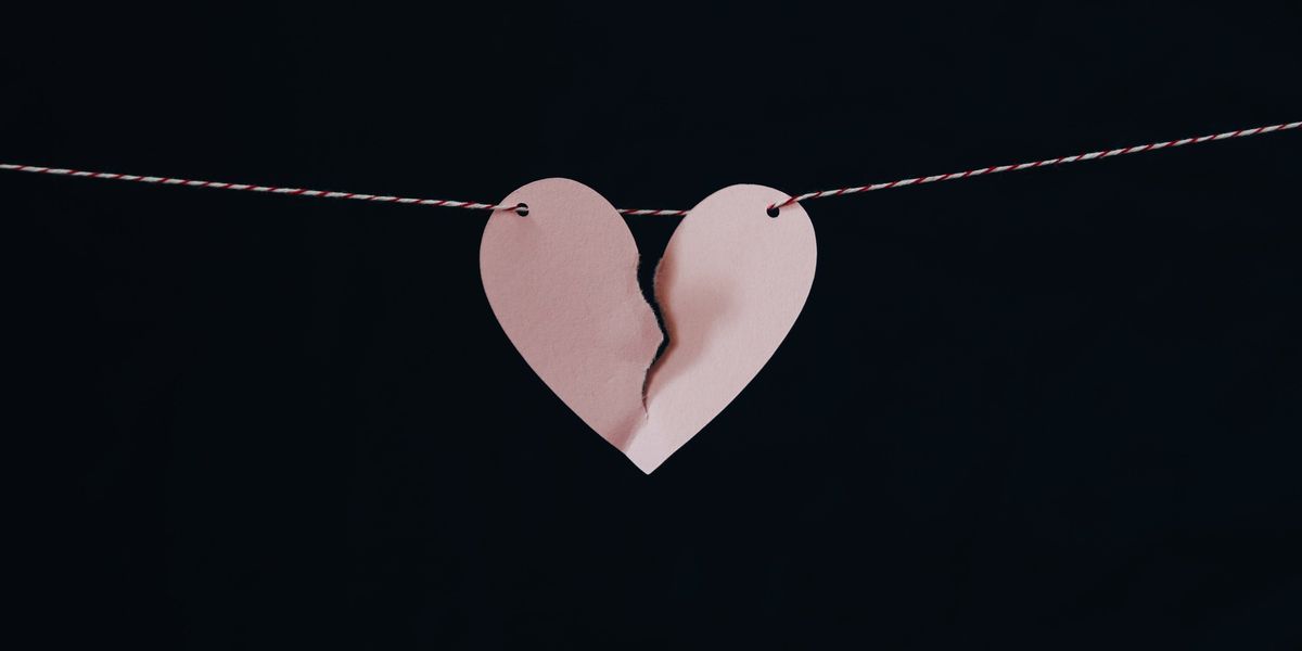 Paper heart ripped in half to symbolize a breakup