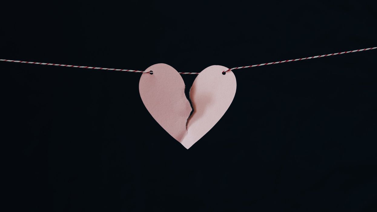 Paper heart ripped in half to symbolize a breakup