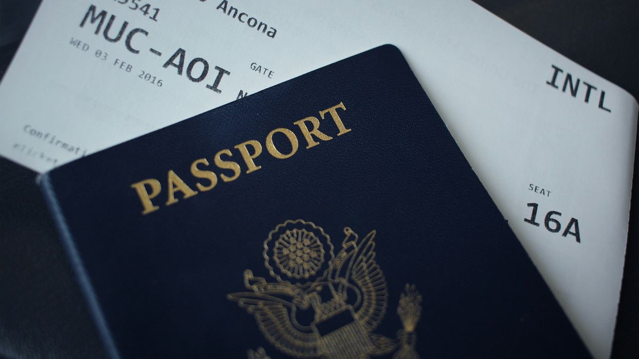 passport booklet on top of plane ticket