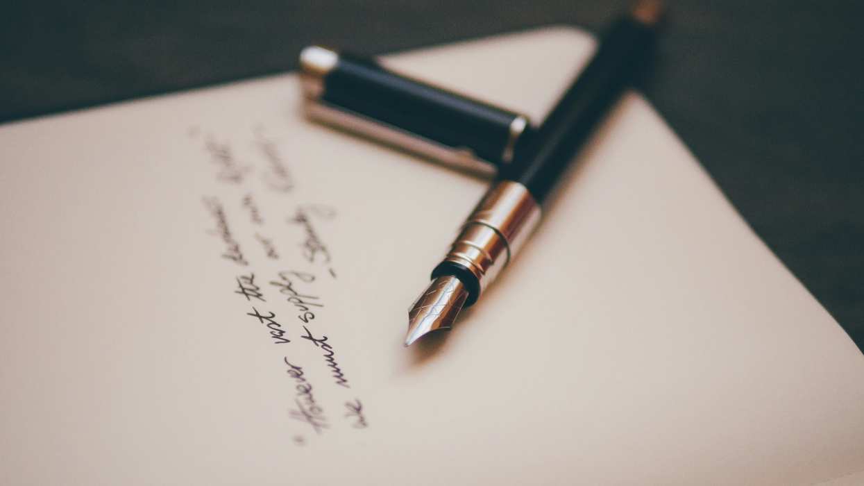 Pen lying on paper with black writing on it
